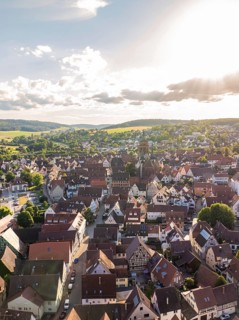 Sunset over a historic town with many rooftops and a striking church in a central location, Weil