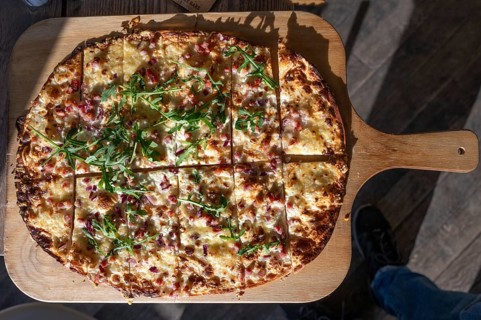 Classic tarte flambée with fresh quark, onions and bacon, Bavaria, Germany
