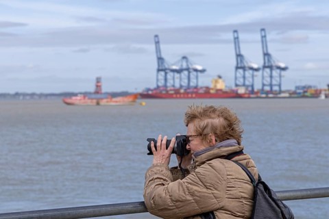 Woman photographed, in the background the container port of Felixstowe, Harwich, England, Great