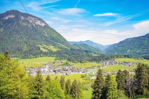 An impressive panorama of a mountain landscape with a valley, a village and forests, Bergdoktor