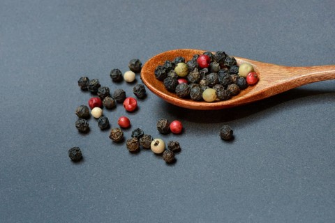 Pepper, various peppercorns in a wooden spoon