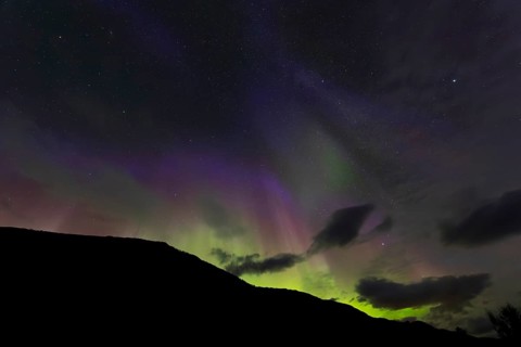 Northern lights at dawn over Sørfolda Fjord near Kjerringøy between Bodø and Sørfold in Norway