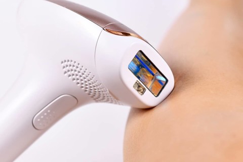 IPL Intense Pulsed Light laser hair removal home device next to bare leg