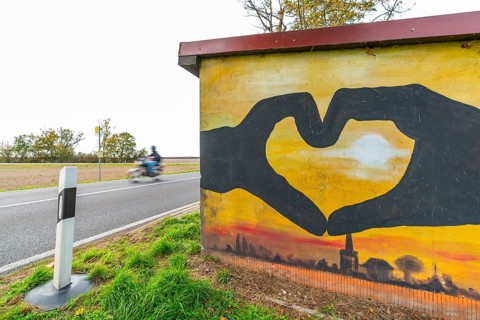 Symbolic photo, graffito of two hands shaped like hearts on the bus shelter of a bus stop on a