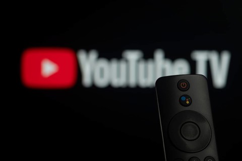 Dhaka, Bangladesh- 21 Jan 2026: Close-up of a smart TV remote control against a blurred Youtube TV