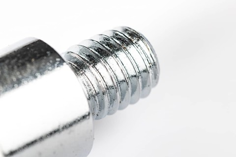 Close-up of a metal thread on a white background