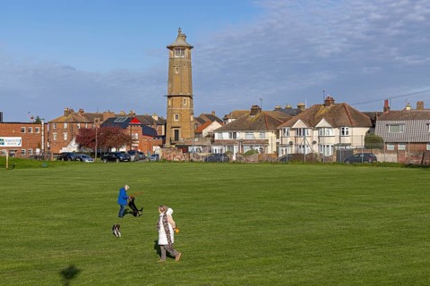 Old lighthouse, High Lighthouse, houses, green space The Green, people, dogs, Harwich, England,