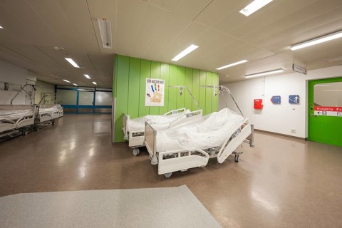 Hospital corridor with beds on the walls and green color theme, Nagold Hospital of the Southwest