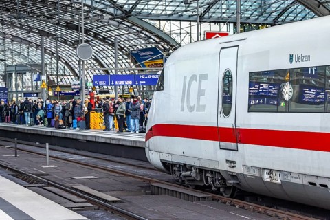Berlin Central Station. Travelers on the platform. Incoming ICE. Berlin, Germany