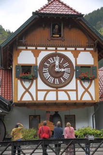 World's largest cuckoo clock and tourists watching clock games, historic building, world record,