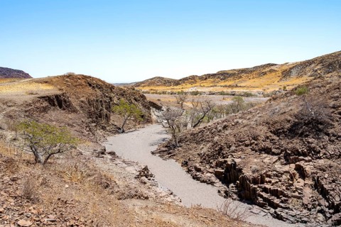 Dry river valley with basalt rocks, rock formation Organ Pipes, Damaraland, Kunene, Namibia