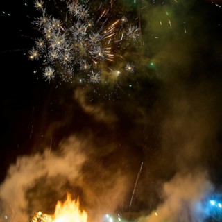 ©Udo Rein, Spectacular fireworks in the night sky with smoke and sparks over a burning fire, Easter
