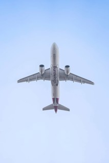 Eurowings aircraft flies past the blue sky, Stuttgart Airport, Germany