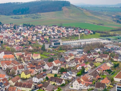 View of a cluster of residential buildings with tiled roofs in a hilly landscape, Großbottwar,