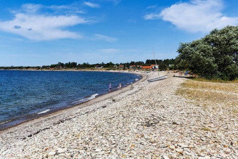 Picturesque stone coast with curved pebble beach, Djupvik, west coast, Kalmarsund, Baltic Sea,