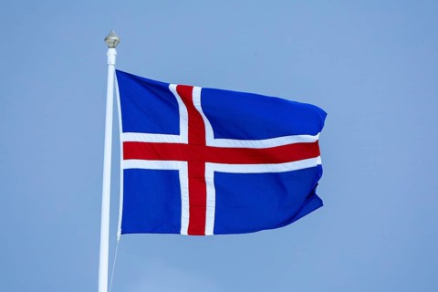 Iceland flag flying on mast, Iceland, Scandinavia