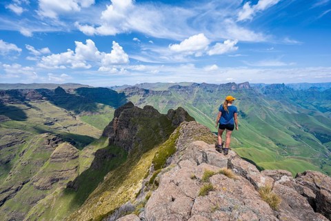 Female mountaineer at the summit of Cathedral Peak or Cathedralpiek or Mponjwana, Drakensberg,