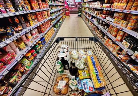 Shopping cart with goods is pushed through an aisle, supermarket, Germany