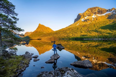 Young man in front of picturesque mountain landscape in the Innerdalen high valley with