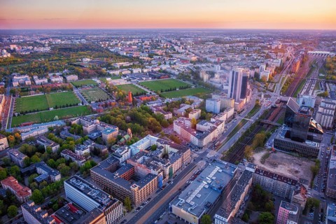 Broad view across the Warsaw skyline in Poland with skyscrapers, cityscape layers, warm roof