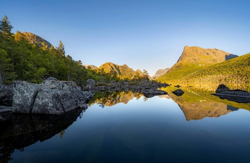 Picturesque mountain landscape in the Innerdalen high valley, Innerdalstårnet peak reflected in