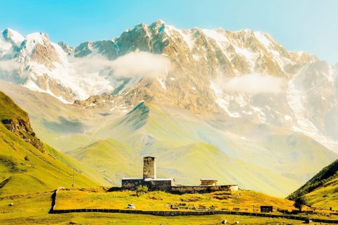 Aerial view Lamaria Monastery with snow-covered Shkhara peak - highest mountain in Georgia.Famous