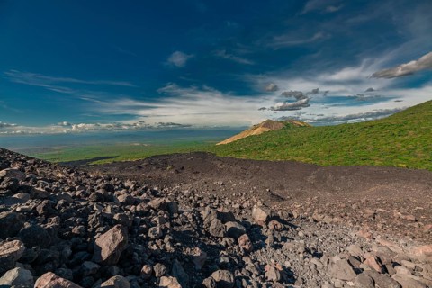 Beautiful view of a vegetated hill surrounded by volcanic rocks. Panoramic view from Cerro Negro,