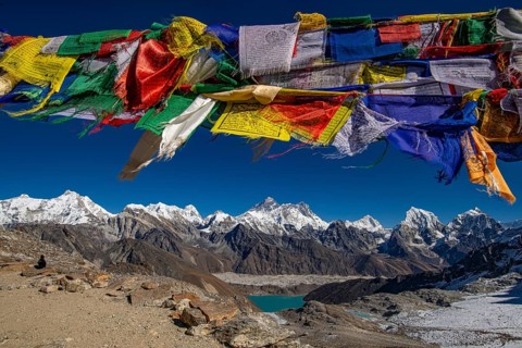View from Renjo La Pass, 5360 m with Buddhist prayer flags with holy mantras with views of the