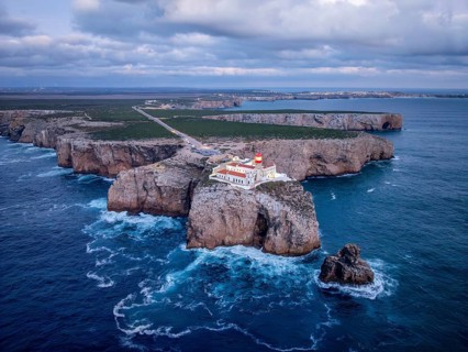 Drone view of the Lighthouse of Cabo de Sao Vicente in Sagres, Algarve, Portugal, at evening with