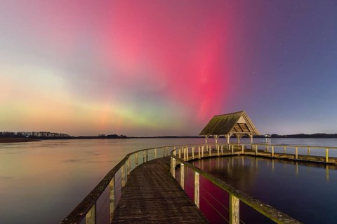 Wooden jetty and Northern Lights, Aurora borealis, polar lights over Lake Hemmelsdorf,