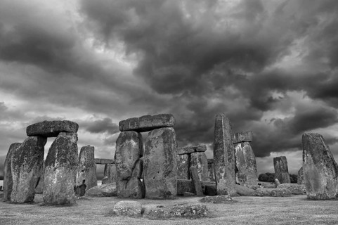 Stonehenge around 3000 BC, a megalithic structure from the Neolithic period, rain clouds, black and