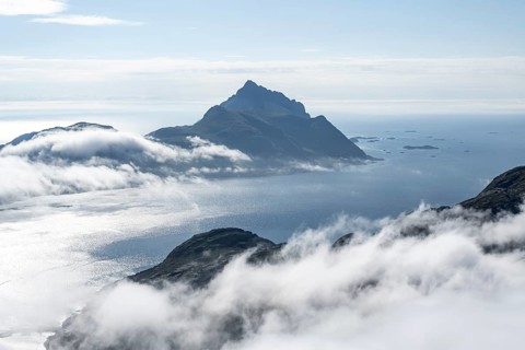 Mountain landscape and sea, view from Stornappstinden summit over sea of clouds, Lofoten, Nordland,