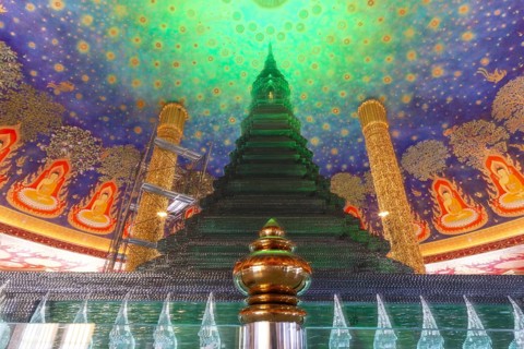 In the emerald green silence of Wat Paknam Phasi Charoen, the glass chedi rises like a glowing