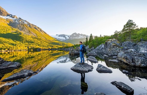 Young man enjoying the landscape, picturesque mountain scenery in the Innerdalen high valley,