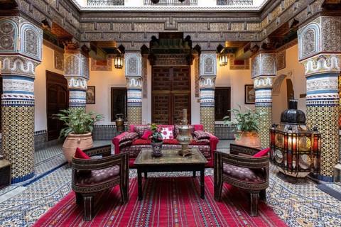 Oriental courtyard with carpet and beautiful furnishings at Hotel Riad Palais Sebhan, former city