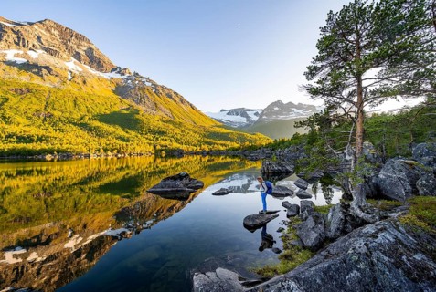 Young woman enjoying the landscape, picturesque mountain scenery in the Innerdalen high valley,