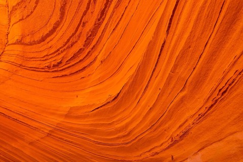 Biidi the arch cave in page, arizona, showcasing vibrant orange sandstone layers and intricate