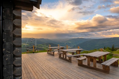 View over a café terrace in the mountains of Gol at sunset, Hallingdal, Buskerud, Norway