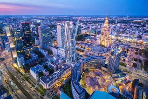 Wide city view over Warsaw, Poland, with the Palace of Culture landmark, skyline, evening glow,