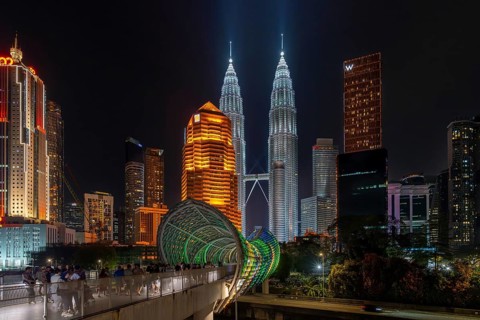Saloma Link, Petronas Towers, KLCC Twin Towers and skyscrapers illuminated at night in capital city
