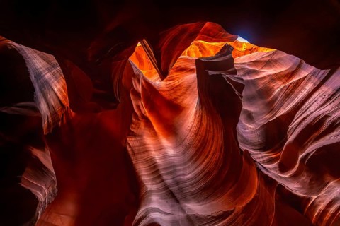 Antelope canyon's upper slot revealing warm orange and red sandstone formations sculpted by water
