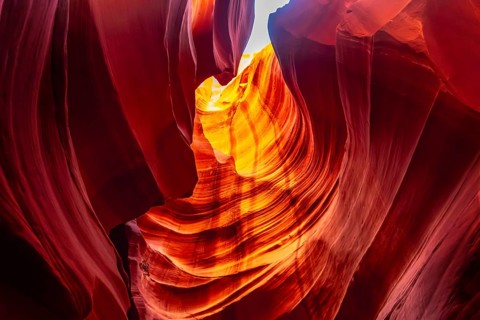 Antelope canyon's narrow slot canyon walls. Carved by water and wind. Displaying rich orange and