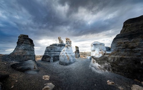 Eroded rock formations, volcanic landscape with dramatic cloudy skies, Ciudad Estratificada or Los