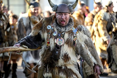 Member of a fools' guild in traditional Haes, fools' clothes, during the carnival procession in