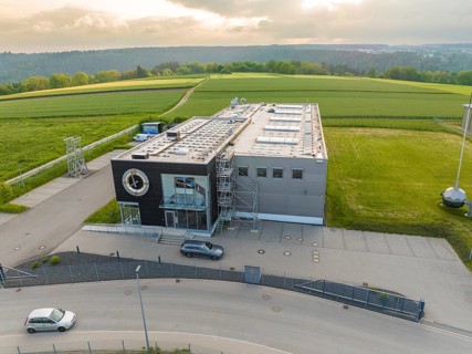 Industrial building on a green field, with a road in the foreground, shipping, Neckar, Wilhelma,
