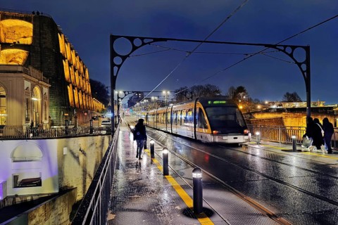 Metro on the Ponte Dom Luis I arched bridge looking towards Vila Nova de Gaia on a rain-wet night,