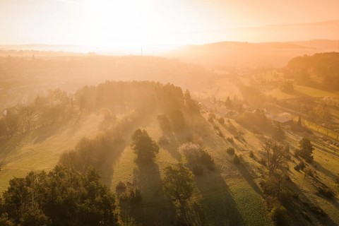 Hilly landscape with sunset and long shadows over meadows, Deufringen, Aidlingen, Heckengäu region,