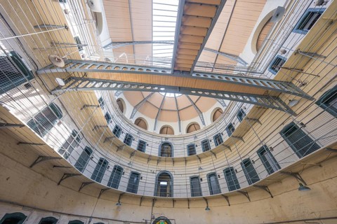 Interior view of a round part of a building with detailed metal structures and window openings,