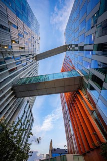 Architectural masterpiece with glass buildings from Google connected by bridges, below a blue sky,