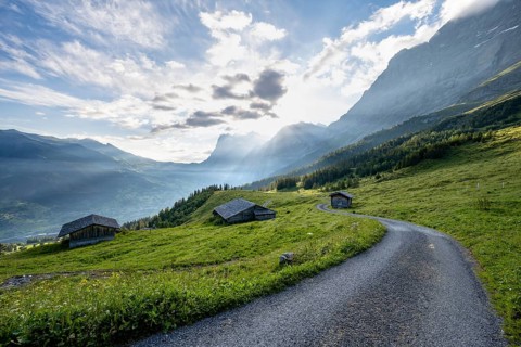 Morning atmosphere, road and mountain huts, alpine meadows, mountains of the Wetterhorn in the